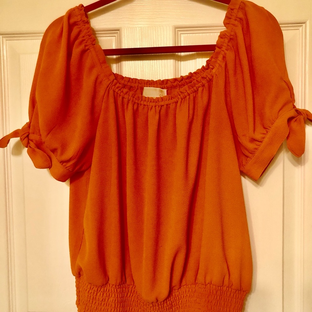 Cute orange designer top with ties on sleeves